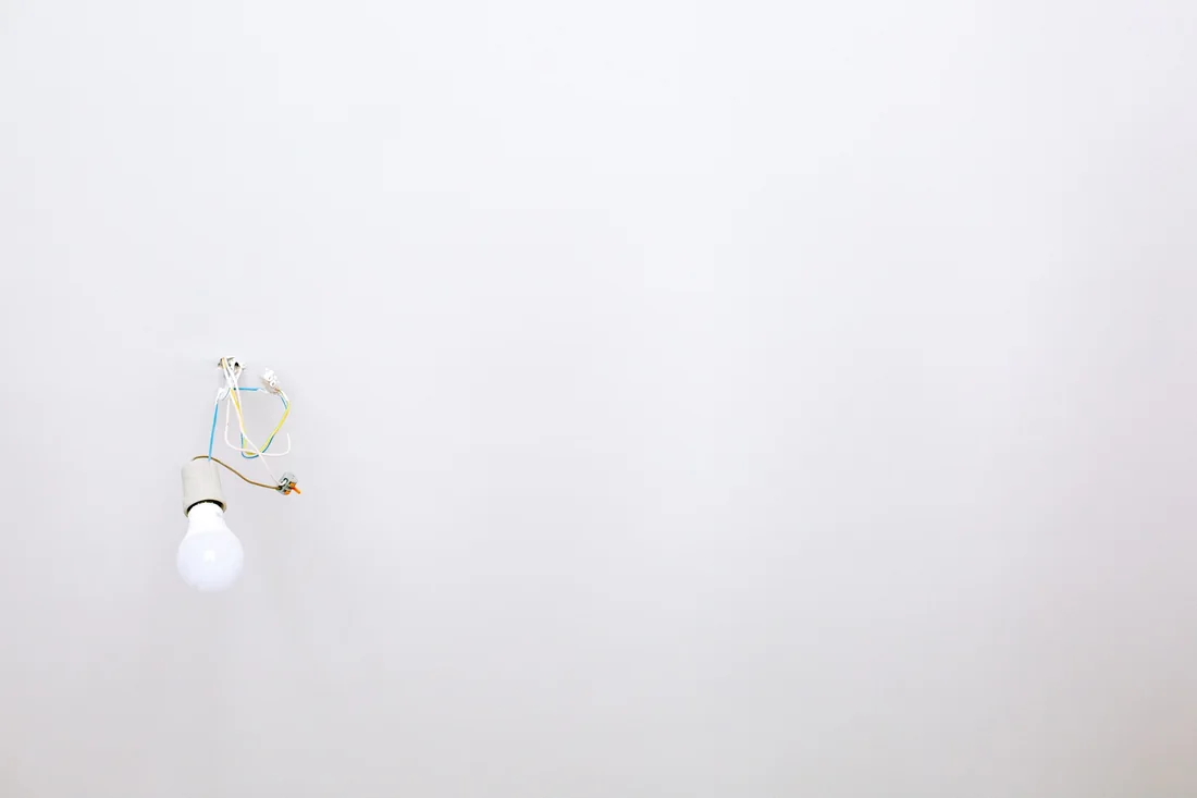 Point lumineux en rénovation avec fils visibles au plafond