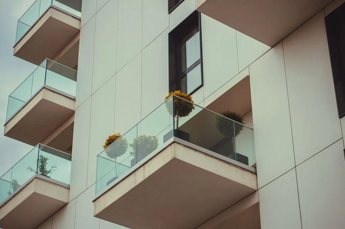 façade d’immeuble avec balcons visibles depuis la rue