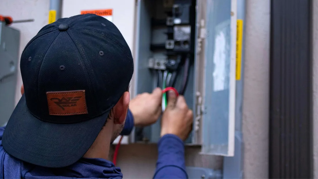 Électricien contrôlant un tableau résidentiel avant redistribution des circuits